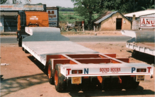 Low bed trailer carrying excavator in Meghalaya